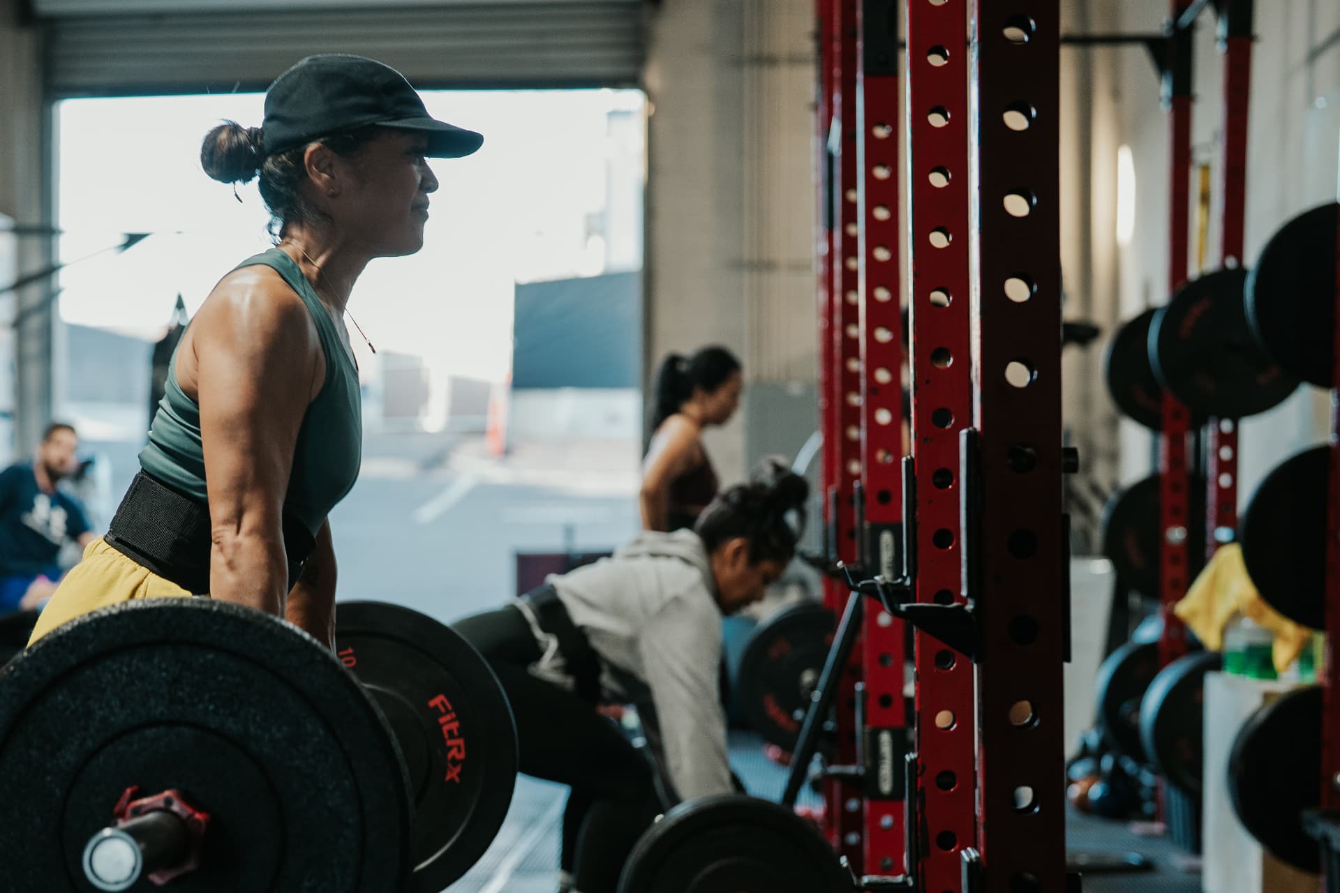 Members deadlifting during a group training session at LionStrong Athletics